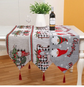 Close-up of festive Christmas table runners with jacquard patterns and red tassels