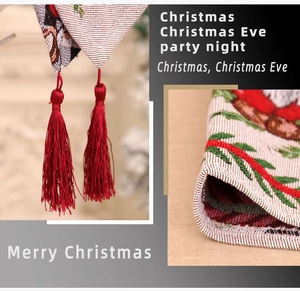 Detailed jacquard knit Christmas table runner with festive Santa patterns and red tassels