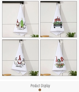 Detailed view of four Christmas kitchen towels featuring gnome prints and hanging loops