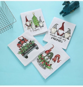 Set of four Christmas hand towels featuring festive gnome and holiday tree prints