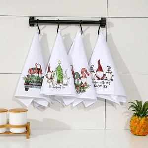 Set of 4 white cotton Christmas kitchen towels featuring gnome prints and festive slogans