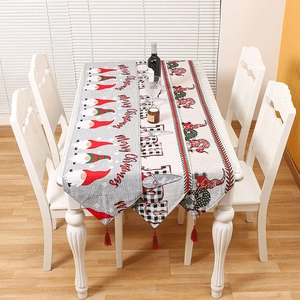 Knitted Christmas table runner with gnomes, tassels, and Merry Christmas text decor