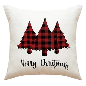Detail of linen texture pillowcase featuring red buffalo plaid Christmas trees design