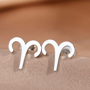 Close-up of Aries zodiac sign stud earrings in polished silver stainless steel