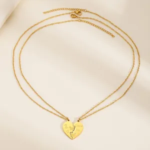 Detail view of gold stainless steel heart necklaces with Big Sis and Little Sis engraving