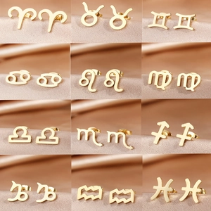 Golden zodiac sign stud earrings set in stainless steel for women on champagne silk background