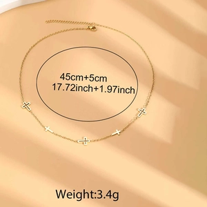 Detail of gold cross pendant necklace with sizing info 45cm plus 5cm length