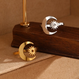 Minimalist sun and moon open rings in polished gold and silver finishes on display