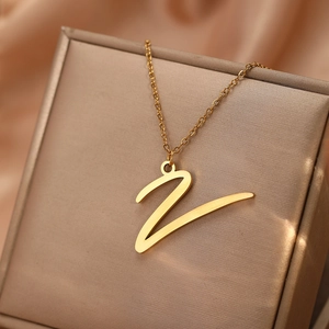 Détail d'un collier avec pendentif lettre Z dorée posé sur une boîte à bijoux