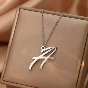 Détail du pendentif lettre A en argent brossé avec texture sur une fine chaîne élégante