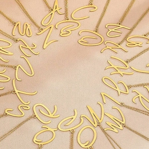 Collection de colliers à lettres initiales en acier doré sur fond de soie douce