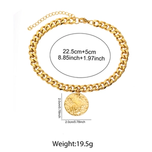 Detail of gold Cuban link anklet with hammered metal disc pendant and extension chain