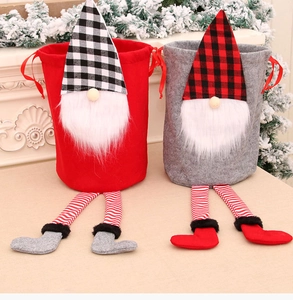 Detail of Christmas gnome gift bags with long legs, plaid hats, and white beards in felt