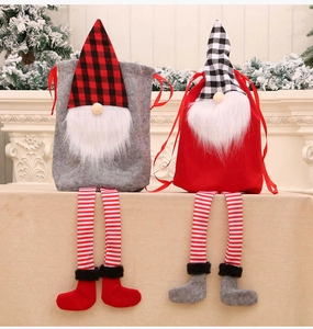 Detail of Christmas gnome gift bags with striped long legs and festive checkered hats