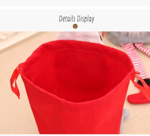 Detail of red Christmas drawstring gift bag with soft texture and ribbon closure
