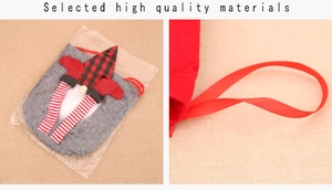 Detail of Christmas gnome gift bag featuring grey felt material and red drawstring closure