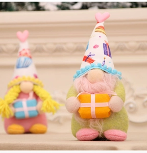 Detail of plush Valentine gnome with pink beard and heart hat near a cozy fireplace