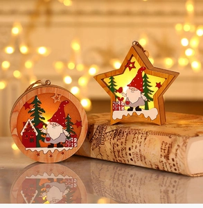 Close-up of LED glowing wooden Christmas ornaments in round and star shapes with gnomes