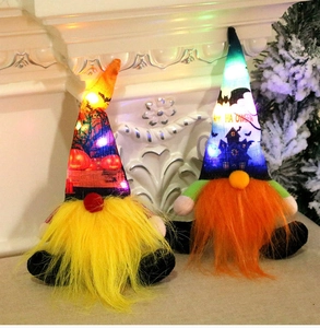 Detail of two glowing Halloween gnomes with LED lights and Happy Halloween motifs