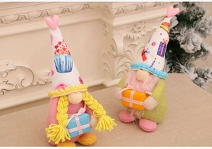 Detail of couple faceless Valentine gnomes with party prints and heart topped hats