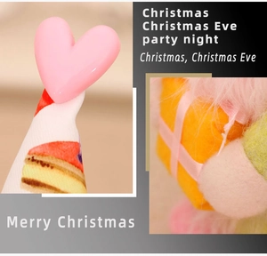 Close-up of faceless gnome detail with cake hat heart and gift box decor