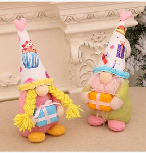 Detail of two handmade Valentine gnomes with cupcake hats and heart gift box decorations