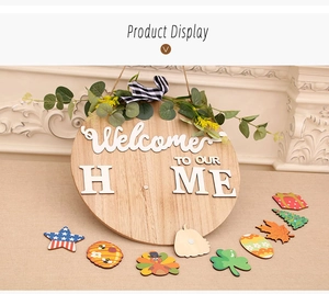 Close-up of wooden welcome sign with interchangeable seasonal icons and plaid bow decoration