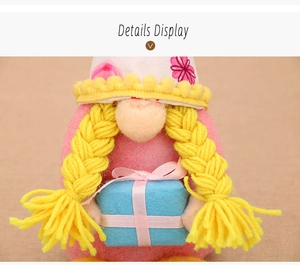 Close-up of handmade faceless gnome doll with yellow braids holding a blue gift box