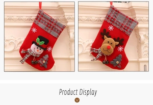 Detail of plush snowman and reindeer Christmas stockings with plaid cuffs and bells