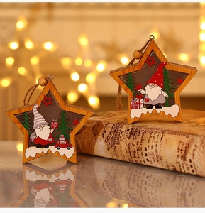 Close-up of star-shaped wooden Christmas pendants featuring Santa and forest elements