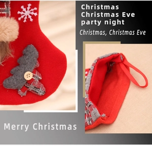 Detail of Christmas stocking featuring grey tree applique, plaid fabric, and hanging loop