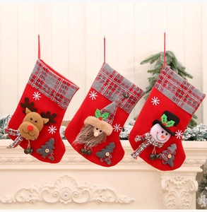 Three Christmas stockings with 3D reindeer and snowman hanging on a white fireplace