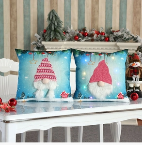 Close-up of LED glowing Christmas gnome pillow cover with cozy embroidery details