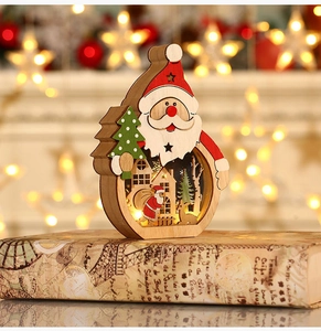 Macro shot of LED lit wooden Santa ornament featuring intricate hollow-carved winter scenes