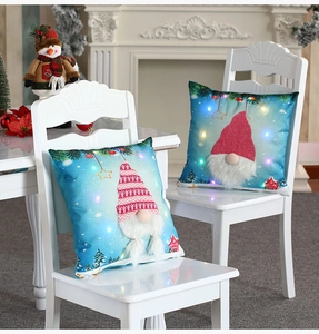 Detail of LED glowing Christmas gnome pillow covers with plush beards and snowy forest scene