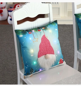 Detail of Christmas gnome pillowcase with LED lights and 3D applique on blue fabric