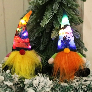 Glowing Halloween gnome set with LED lights and fiber beards on snow-covered pine needles