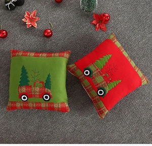 Detail of Christmas pillowcase with embroidered truck and tree on velvet fabric