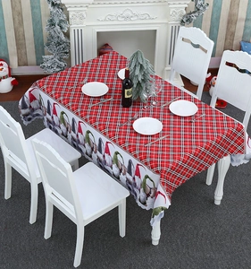 Detailed view of Christmas table runner featuring colorful gnome illustrations and red plaid