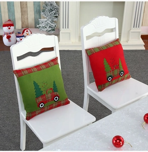 Detailed embroidery of Christmas truck and trees on red and green velvet cushion covers