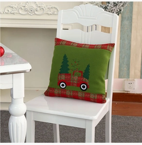 Detail of Christmas pillow cover featuring festive red truck embroidery on green velvet