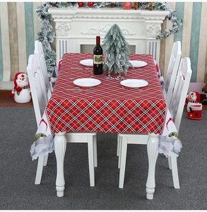 Close-up of Christmas gnome pattern on red and black plaid polyester festive tablecloth