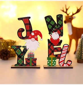 Macro shot of Joy and Noel wooden Christmas desk signs with gnome and snowflake patterns