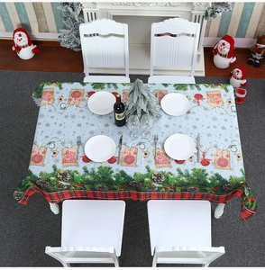 Detailed Christmas tablecloth with pine cones, berries, and festive plaid border pattern