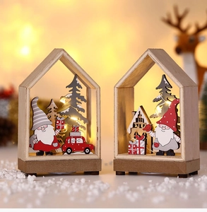 Detail of wooden Christmas house cabin with LED lights and festive gnome miniatures