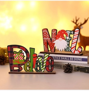 Close-up of DIY wooden Christmas Believe and NOEL signs with red buffalo plaid design