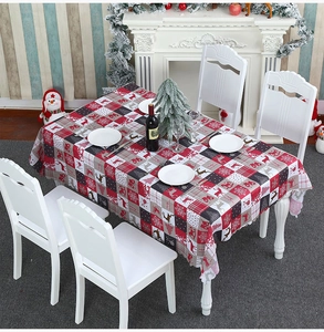 Close-up of a Christmas tablecloth with reindeer patterns and Merry Christmas text