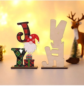 Close-up of JOY wooden Christmas table sign with gnome and red green plaid pattern