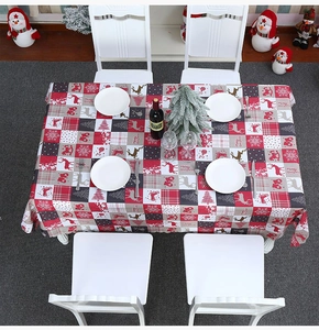 Detail of Christmas tablecloth with elk, snowflake prints and Merry Christmas text