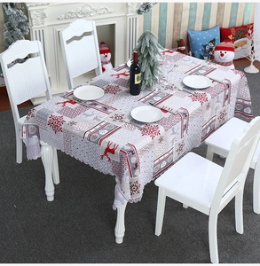 Christmas tablecloth detail with reindeer and snowflake patterns on a dining table